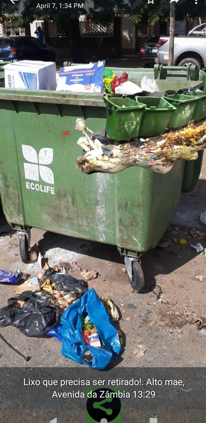 Image of an empty waste container from a private waste company surrounded by garbage. The trash snail AR image floats in the air towards the top of the container.